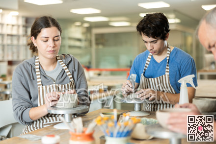 During working day, three pottery workshop workers sculpt from clay, form final product