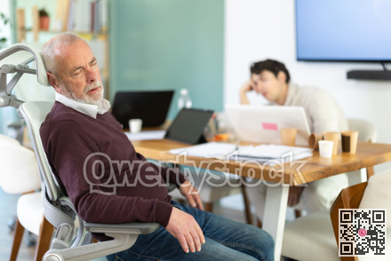 Tired male office workers having nap while sitting in workplace