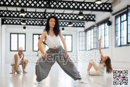 Asian woman studying movement of contemporary dance