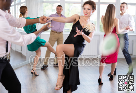 Man and woman practicing swing dance in dancing studio