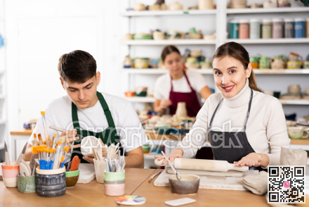 Young woman and young man making pottery