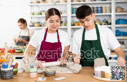 Young woman and young man making pottery