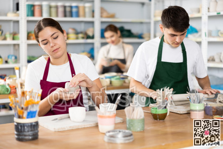 Young woman and young man making pottery