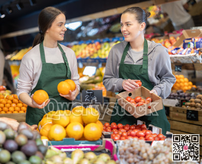 Owners of the grocery store hold ripe fruit in their hands