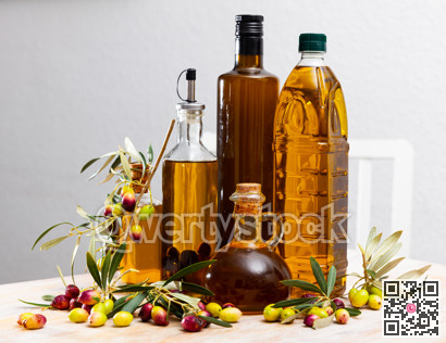 Olive oil in bottles on wooden table