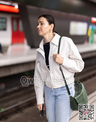 Portrait of woman at metro station waiting for train