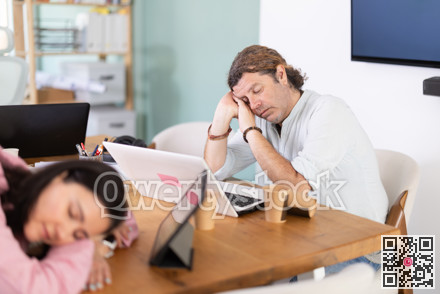 Tired female office worker having nap while sitting in workplace