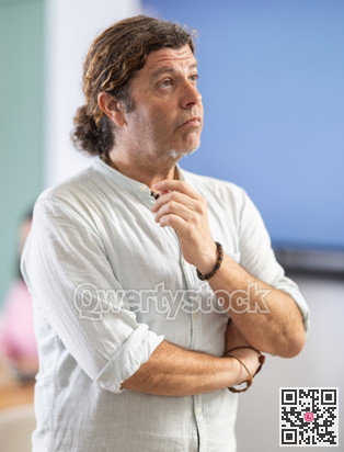 Distressed middle-aged man standing with sad expression in office