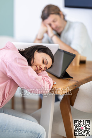 Tired woman fell asleep at his desk in office
