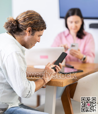 Male use smartphone during meeting or conference. look at screen of mobile phones