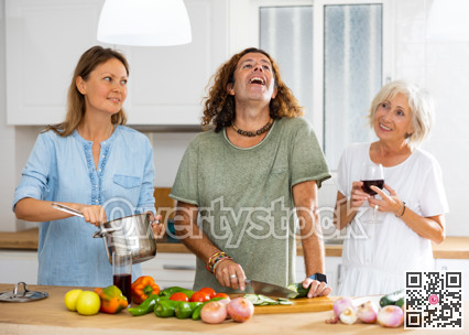 Happy family together with elderly mother preparing lunch in kitchen