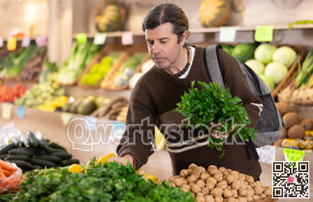 man in a grocery store chooses a fresh aroma parsley