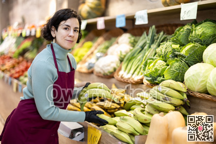 Woman shop seller puts banana goods on display case