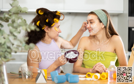 Applying mask to woman's face with brush