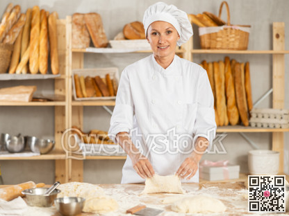 Woman works as baker in bakery, molds pies from dough, creates croissants from dough.