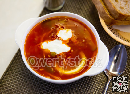 Russian meat soup solyanka with assorted meat and sausages and vegetables