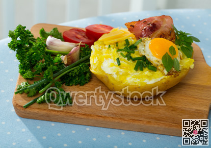 Baked potato stuffed with herbs, egg, bacon