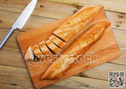Whole and sliced french baguette