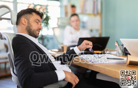 Tired man and girl sleeps next to computer at work