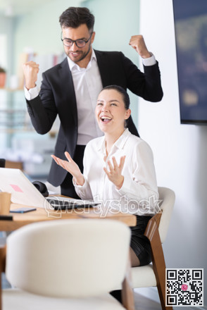 Man and a woman work in an office and are emotionally joy about the success in a new project
