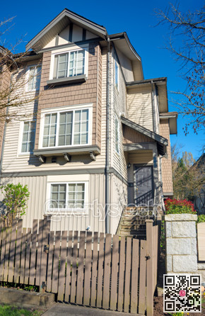 Residential townhouse entrance with wooden fence in front