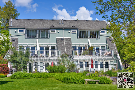 Quadruplex residential building of townhouses on sunny summer day