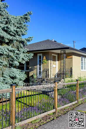 Entrance porch at the corner of residential house with light fence in front
