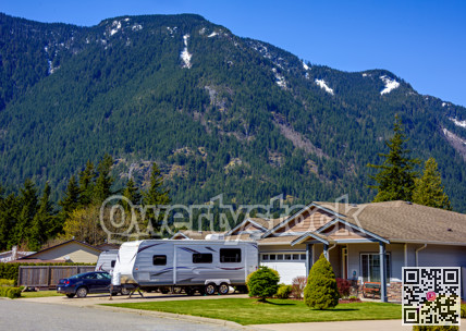 New luxury residential house with car and RV traler parked on driveway