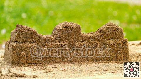 Sand fortress wall created by kids in play