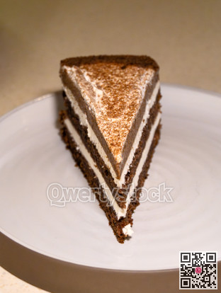Piece of coffee cake with cream on the round plate
