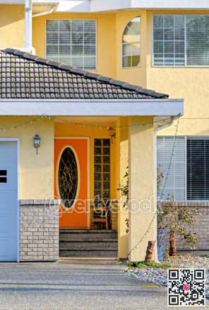 Orange door of residential house main entrance on bright sunny day
